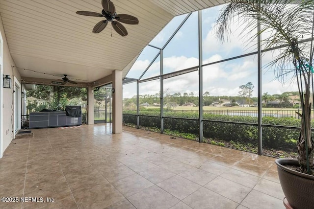 unfurnished sunroom featuring vaulted ceiling and ceiling fan