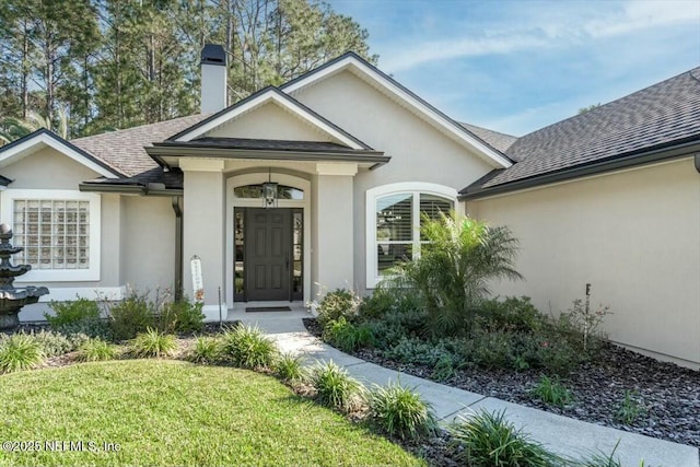 entrance to property with a yard