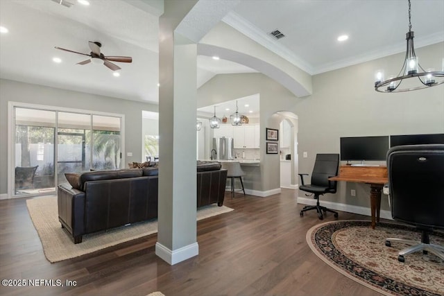 office featuring ceiling fan with notable chandelier, dark hardwood / wood-style flooring, and vaulted ceiling