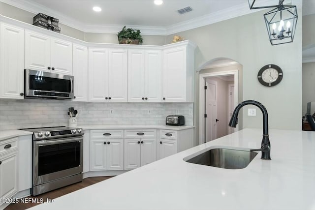 kitchen with stainless steel appliances, white cabinetry, and sink