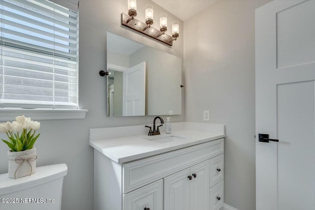 bathroom featuring vanity and toilet