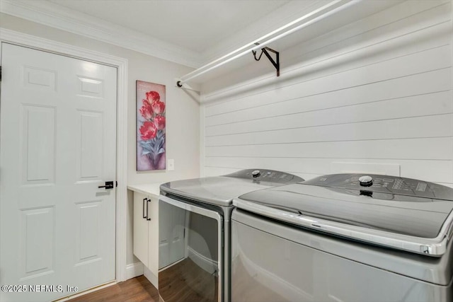 laundry room with hardwood / wood-style flooring, washer and clothes dryer, and ornamental molding