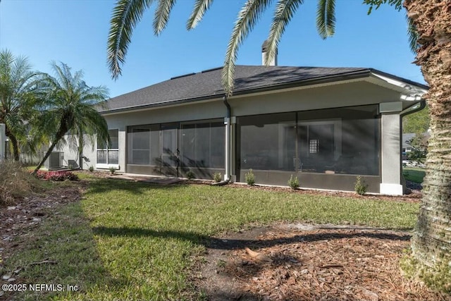 rear view of house featuring a sunroom, a yard, and cooling unit