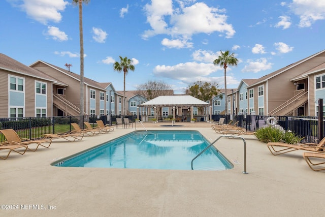 view of swimming pool with a gazebo and a patio area