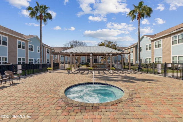 view of swimming pool with a gazebo and a hot tub