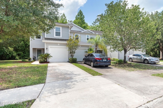 view of front of property with a garage and a front lawn