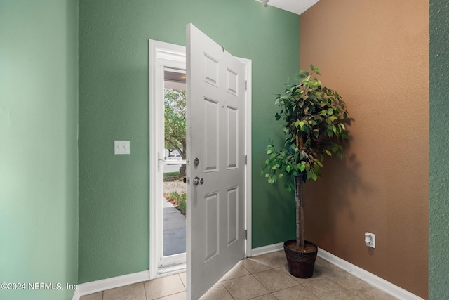 entryway featuring light tile patterned flooring