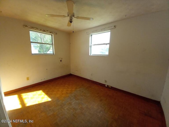 empty room with parquet flooring and ceiling fan