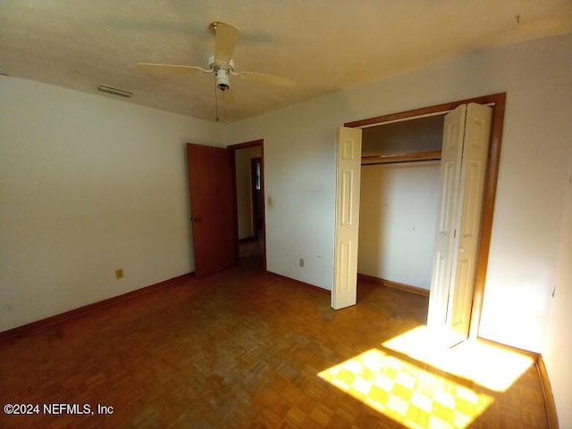 unfurnished bedroom with light parquet flooring, a closet, and ceiling fan