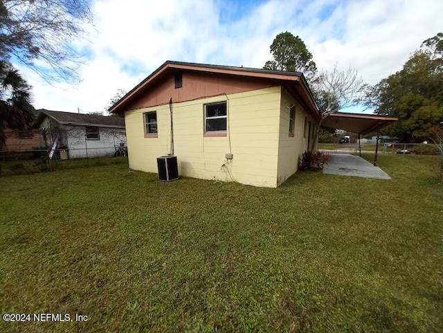 back of house featuring a yard, a patio, and central air condition unit