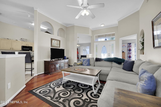 living room with hardwood / wood-style floors, ceiling fan, and ornamental molding