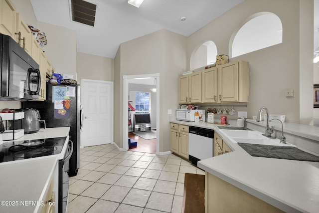 kitchen with sink, light tile patterned floors, white appliances, and high vaulted ceiling