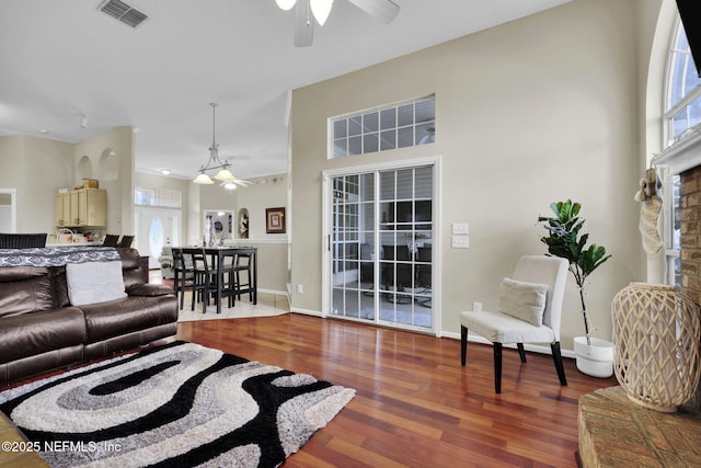 living room with a fireplace, hardwood / wood-style floors, and ceiling fan