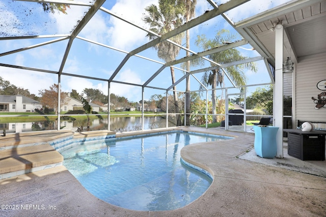 view of swimming pool with glass enclosure, a patio area, and a water view