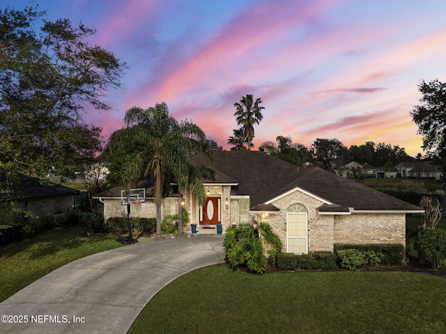 ranch-style home featuring a lawn