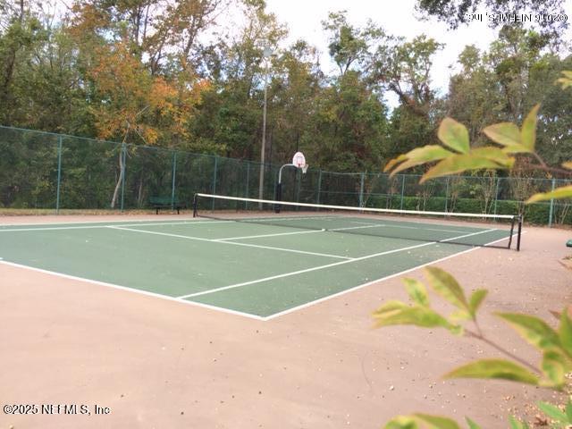 view of tennis court featuring basketball court