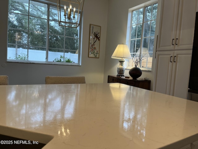 unfurnished dining area with a notable chandelier