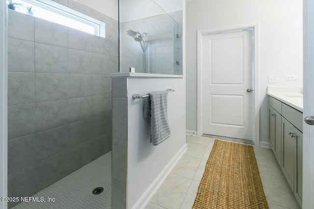 bathroom featuring tile patterned floors, vanity, and tiled shower