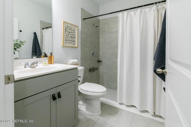 bathroom with tile patterned floors, a shower with curtain, toilet, and vanity