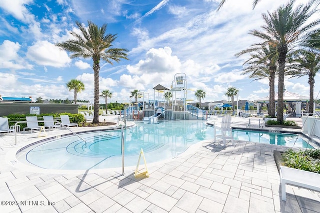 view of pool with a playground