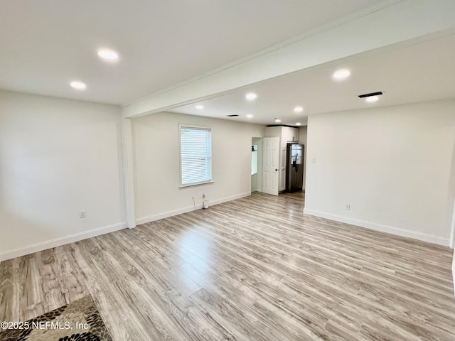 interior space featuring light hardwood / wood-style flooring and stainless steel fridge