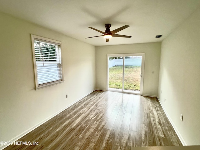 unfurnished room with hardwood / wood-style flooring and ceiling fan