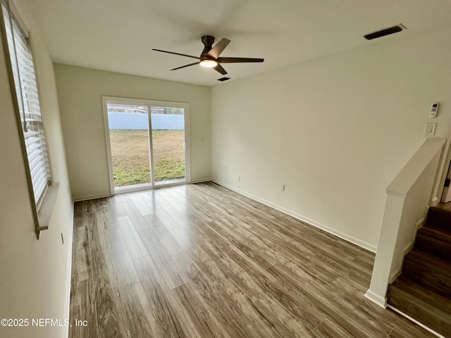 unfurnished room with hardwood / wood-style floors and ceiling fan