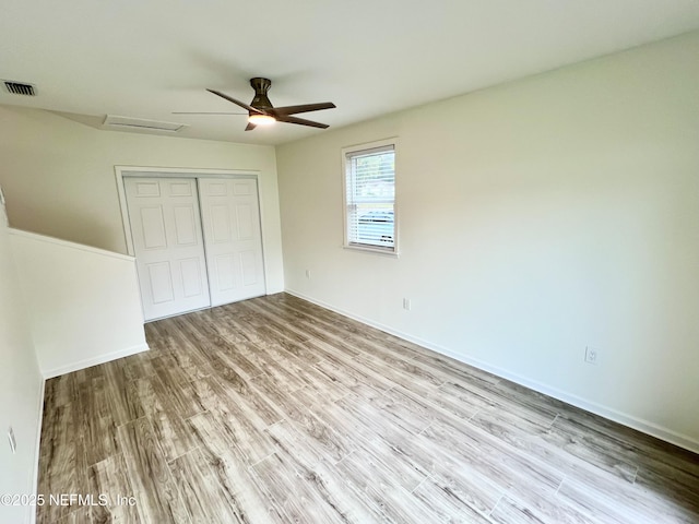 unfurnished bedroom with a closet, ceiling fan, and light wood-type flooring