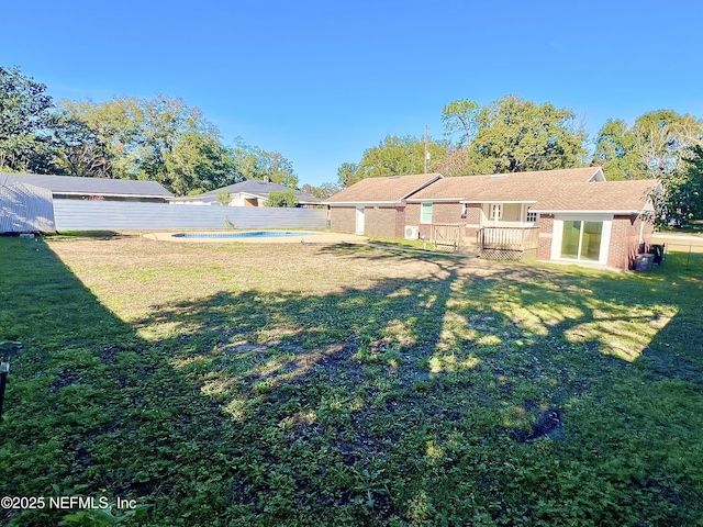 view of yard with a fenced in pool