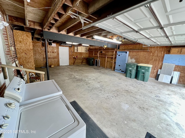 garage with washer / clothes dryer and wood walls