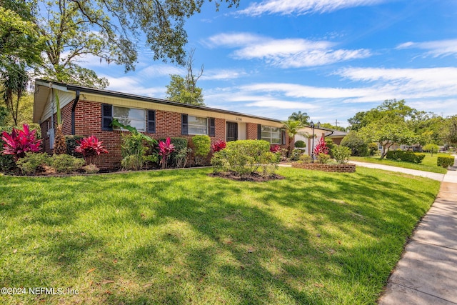 ranch-style house with a front lawn