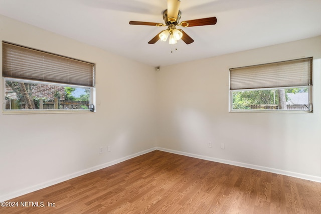 empty room featuring hardwood / wood-style flooring and ceiling fan