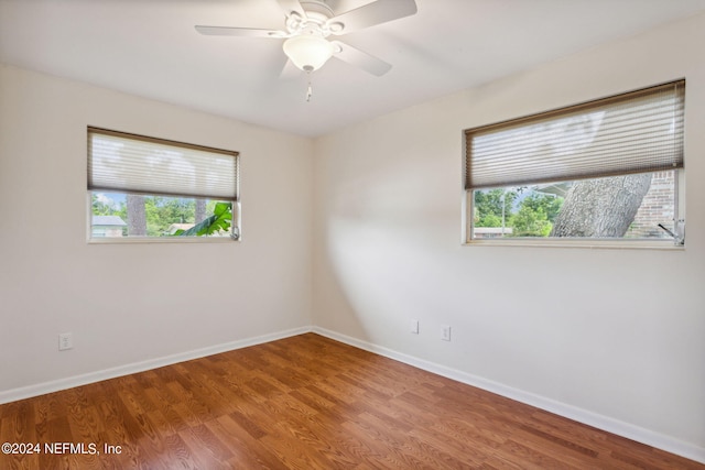 spare room featuring ceiling fan and hardwood / wood-style floors