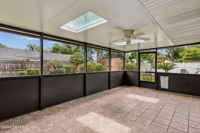 unfurnished sunroom with a skylight and ceiling fan