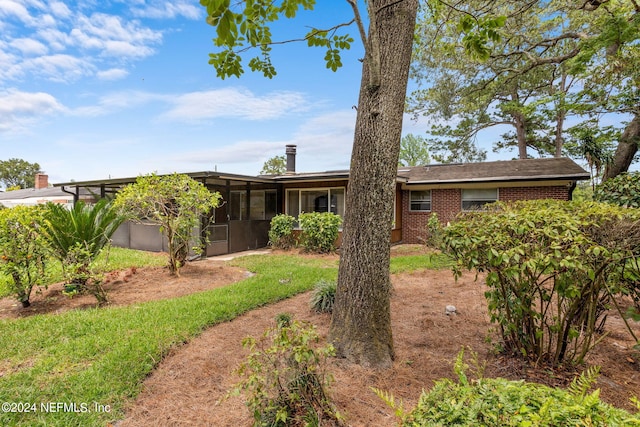 view of front of home with a sunroom