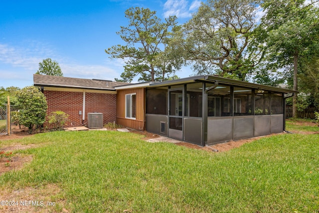 back of house featuring a yard, central AC, and a sunroom