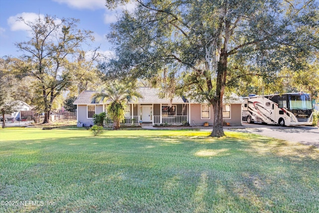 view of front of property with covered porch and a front lawn