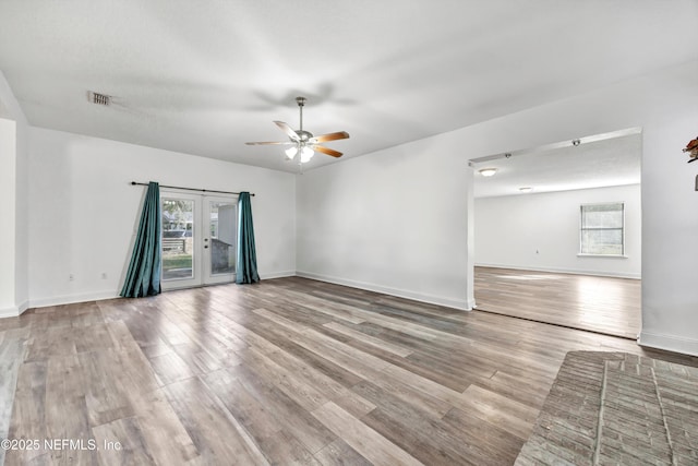 spare room with ceiling fan, light hardwood / wood-style floors, and french doors