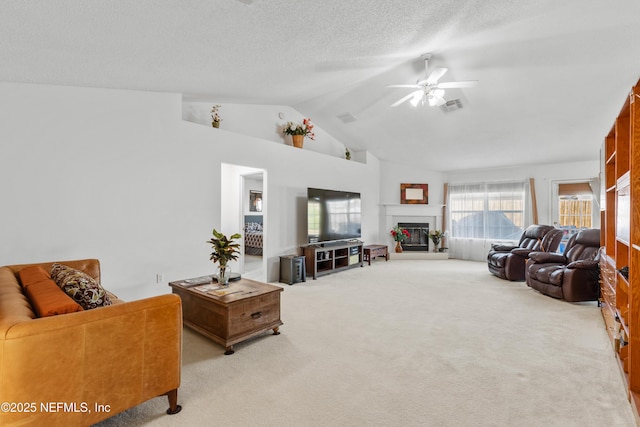 living room featuring light carpet, a textured ceiling, vaulted ceiling, and ceiling fan