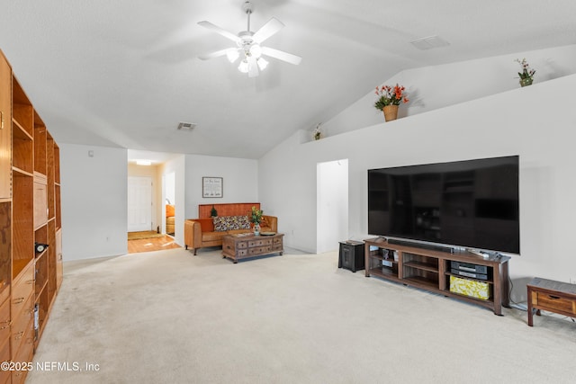 living room with carpet flooring, vaulted ceiling, and ceiling fan