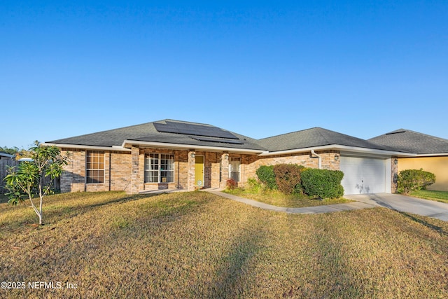 prairie-style house with solar panels, a front lawn, and a garage