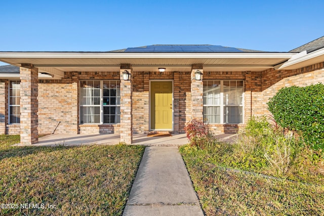 property entrance with solar panels and covered porch