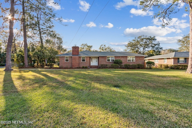 5140 Ortega Blvd, Jacksonville, FL 32210 - back of property featuring a chimney, brick siding, and a lawn