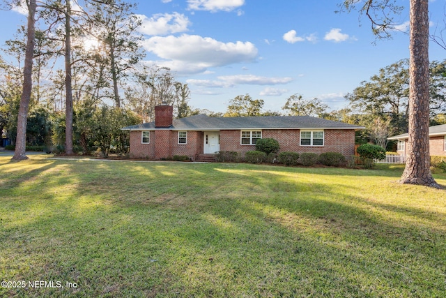 5140 Ortega Blvd, Jacksonville, FL 32210 - ranch-style home with a chimney, brick siding, and a front yard