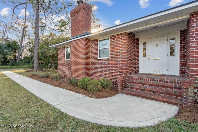 5140 Ortega Blvd, Jacksonville, FL 32210 - doorway to property featuring a chimney and brick siding