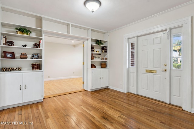 foyer featuring ornamental molding and hardwood / wood-style floors