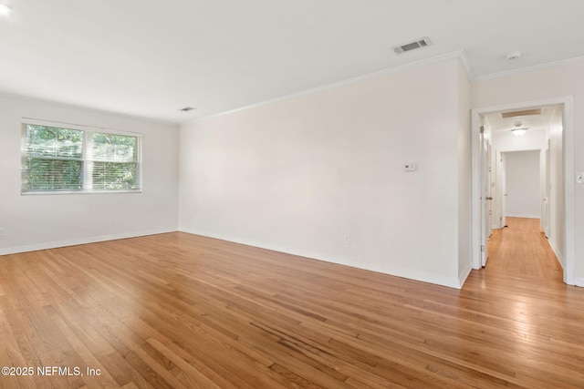 unfurnished room featuring light hardwood / wood-style flooring and crown molding