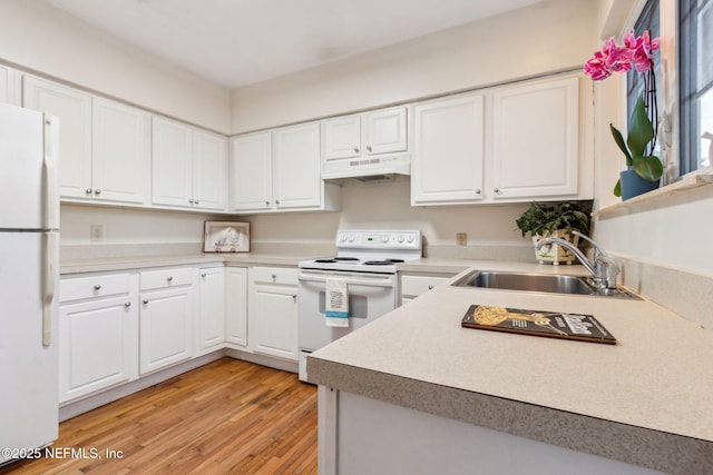 kitchen featuring sink, white appliances, white cabinetry, and light hardwood / wood-style floors