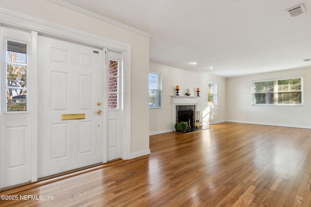 foyer featuring hardwood / wood-style floors and ornamental molding