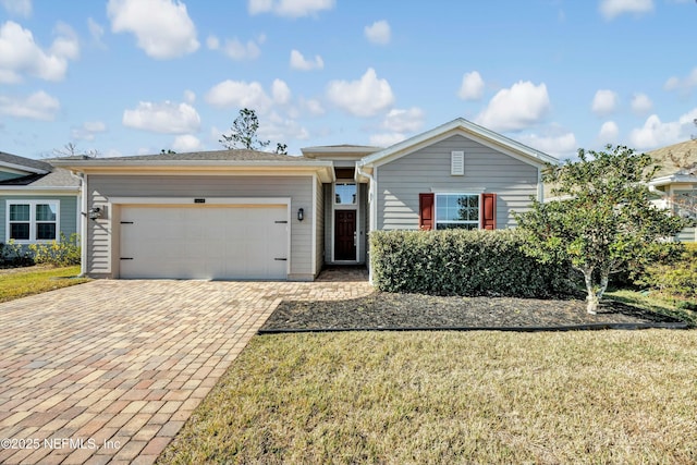 single story home with a garage and a front lawn